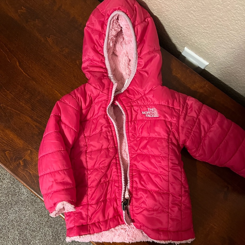 Pink 6 to 12 month North face jacket. Fits big. In great condition